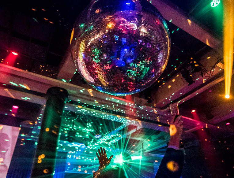 Lux Frágil Lisbon riverside terrace at night with Tagus river view and illuminated interior