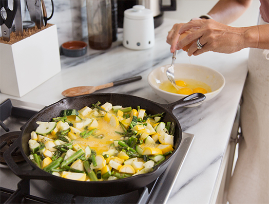 Michelle Manix making scrambled eggs for breakfast