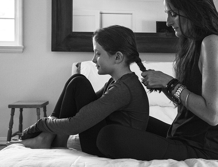 Danielle braiding her daughter's hair