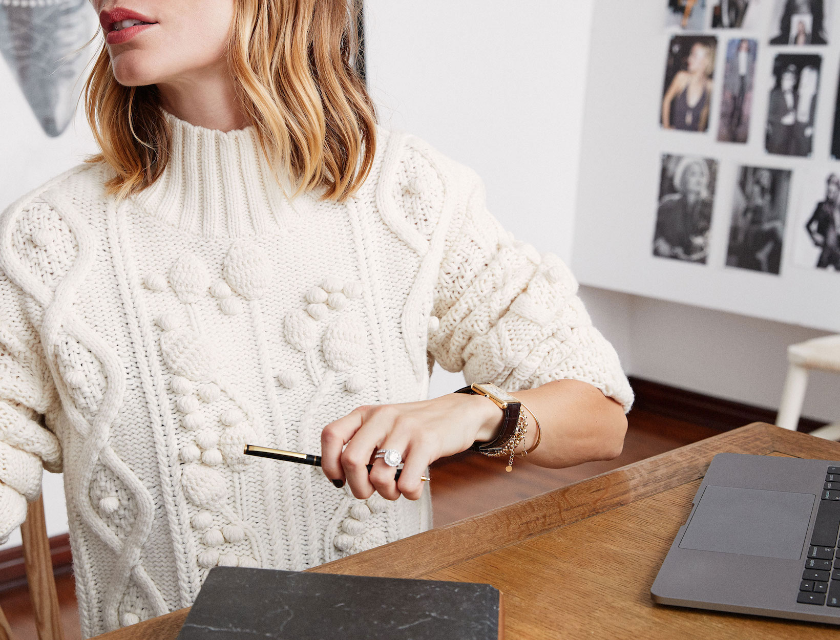Woman in white sweater working at computer