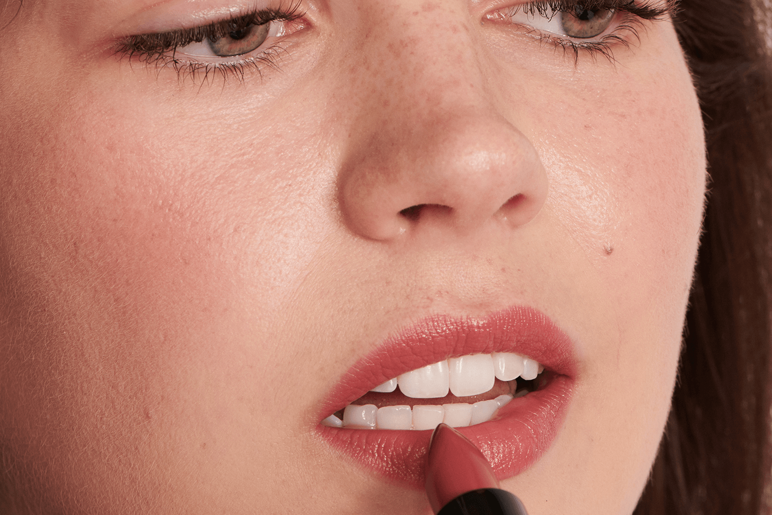 Model putting on lipstick