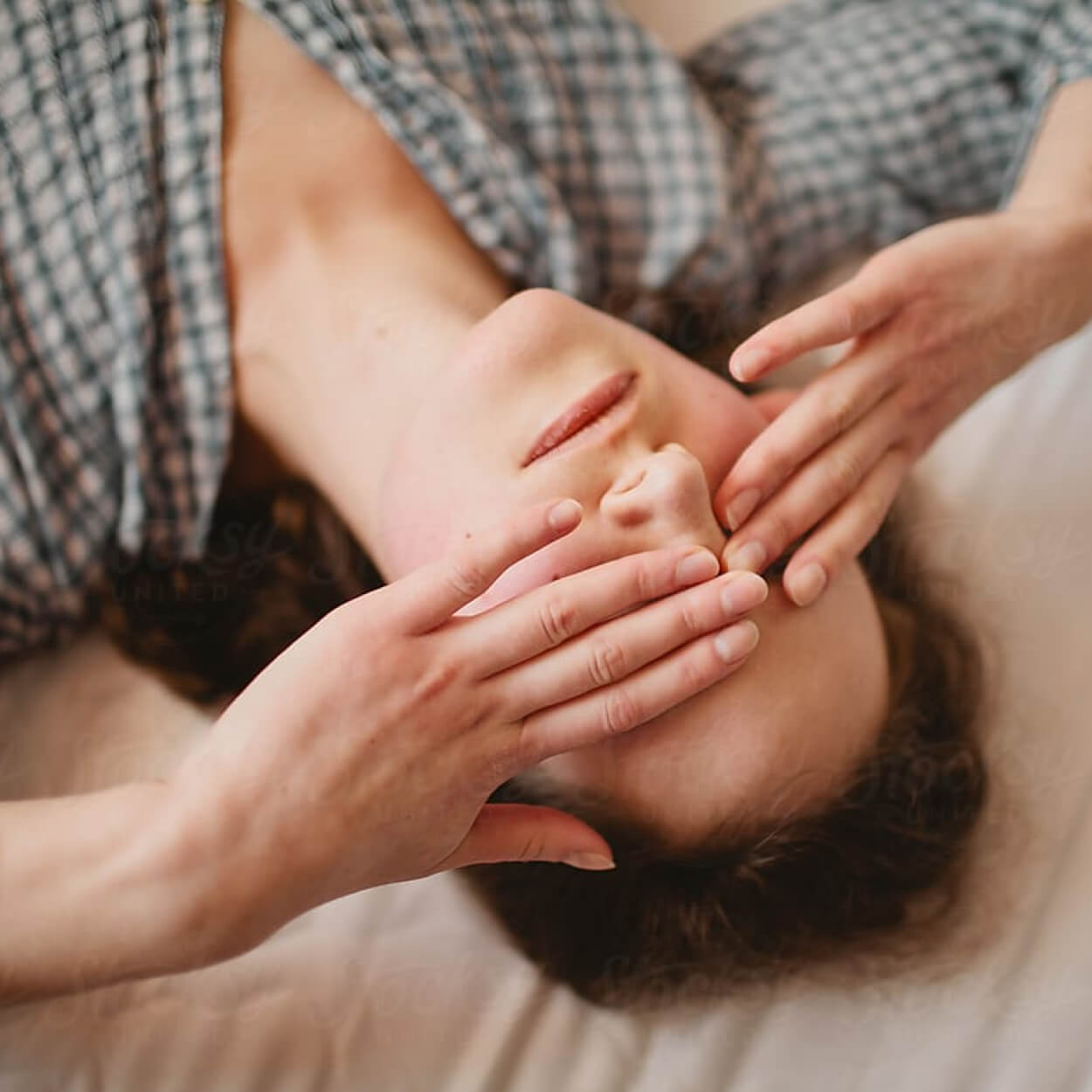 woman laying down and covering her eyes