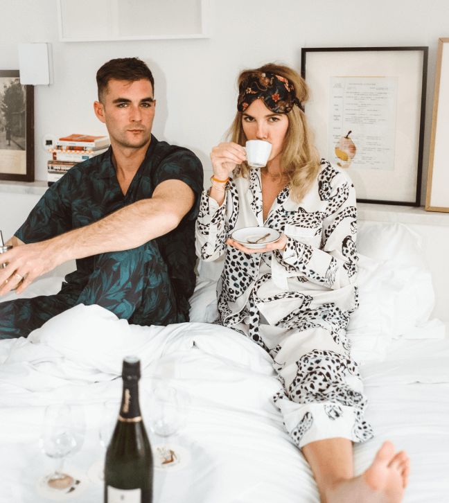 man and woman in pajamas in bed