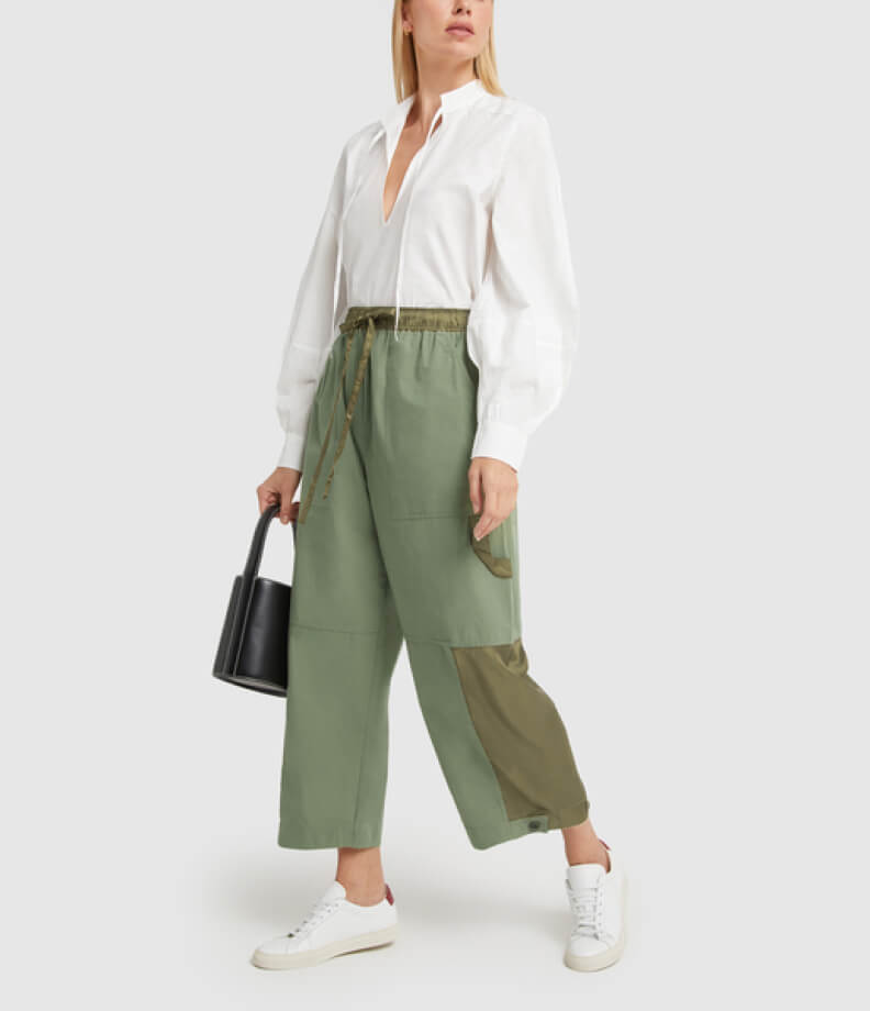 woman in GANNI BLOUSE and LEE MATHEWS PANTS