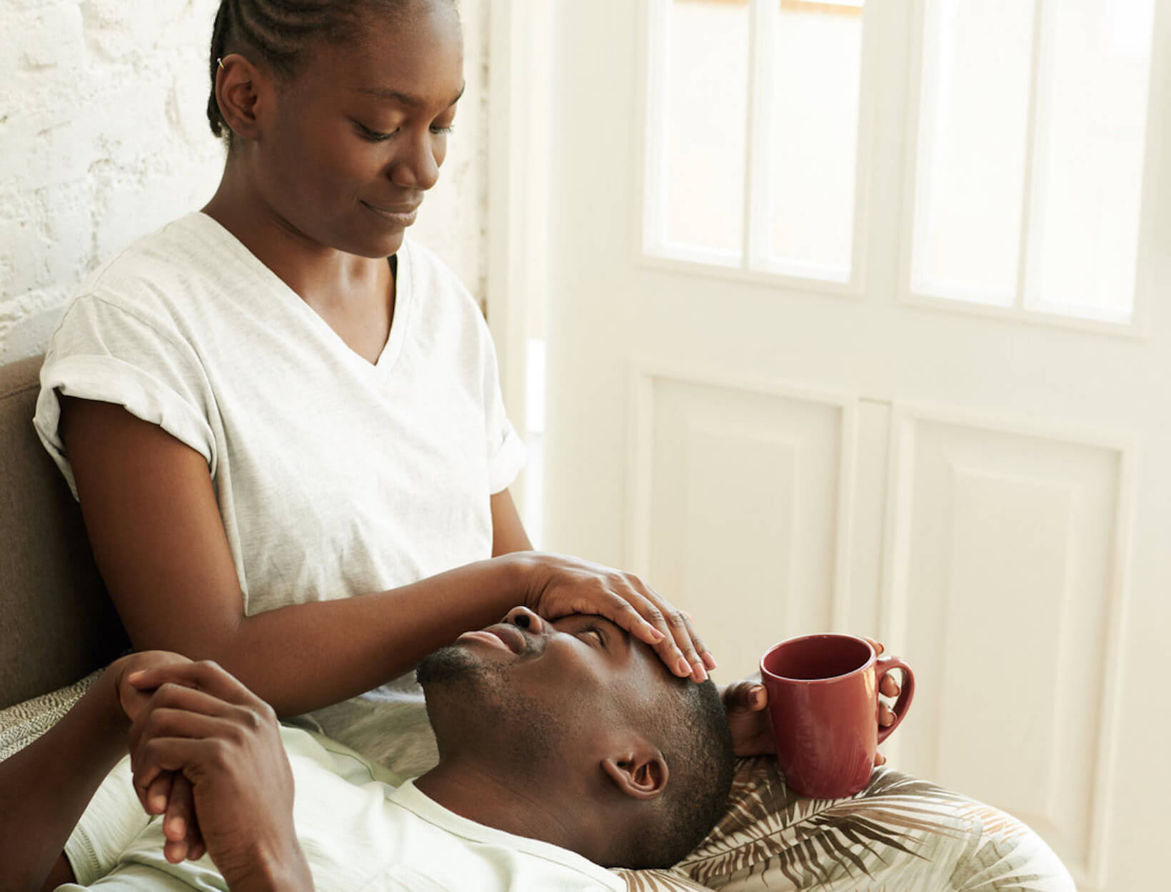 man resting head on woman's lap