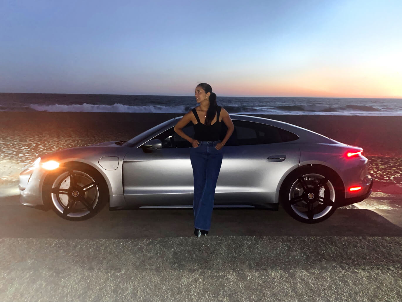 renee rupcich posing next to a porsche