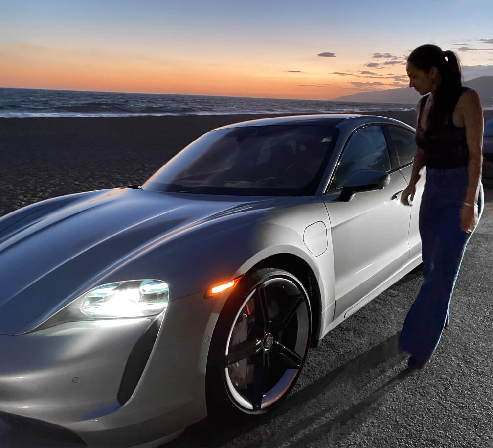 renee rupcich posing next to a porsche