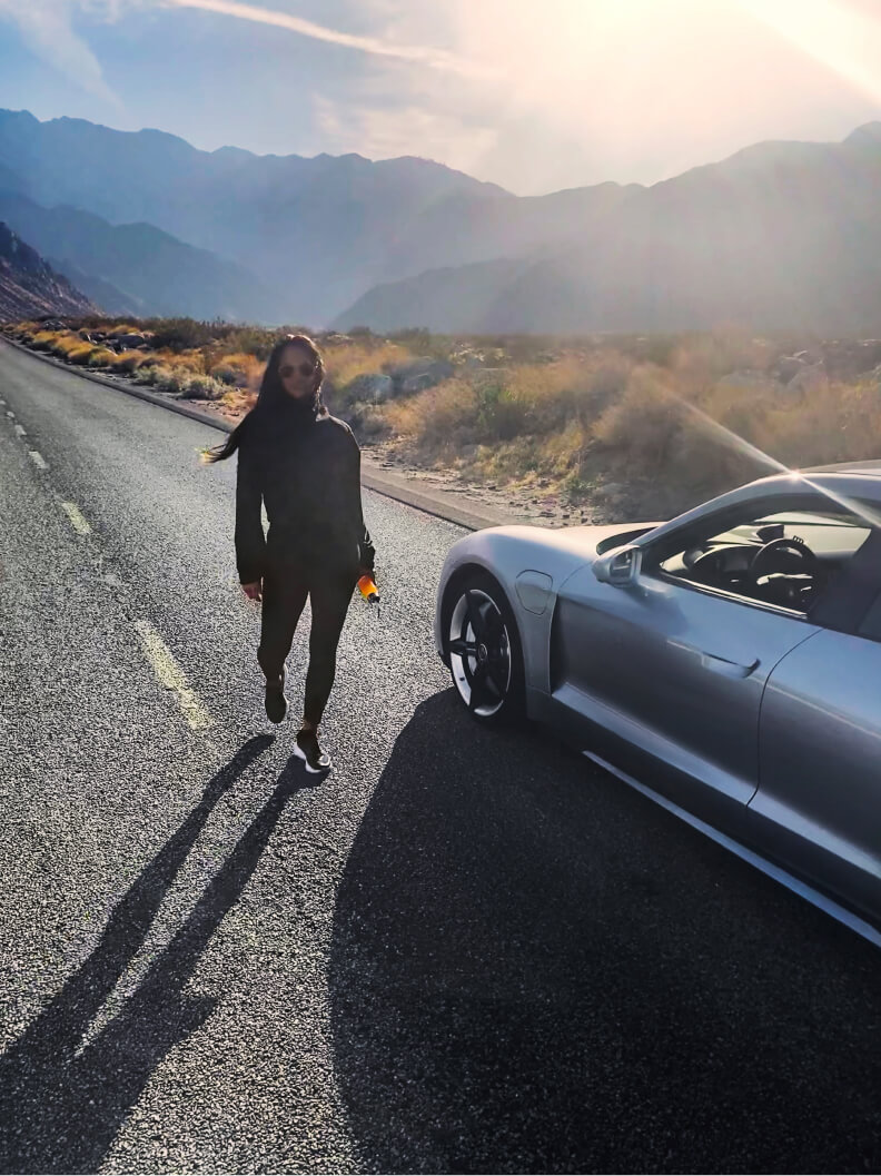 renee rupcich posing next to a porsche