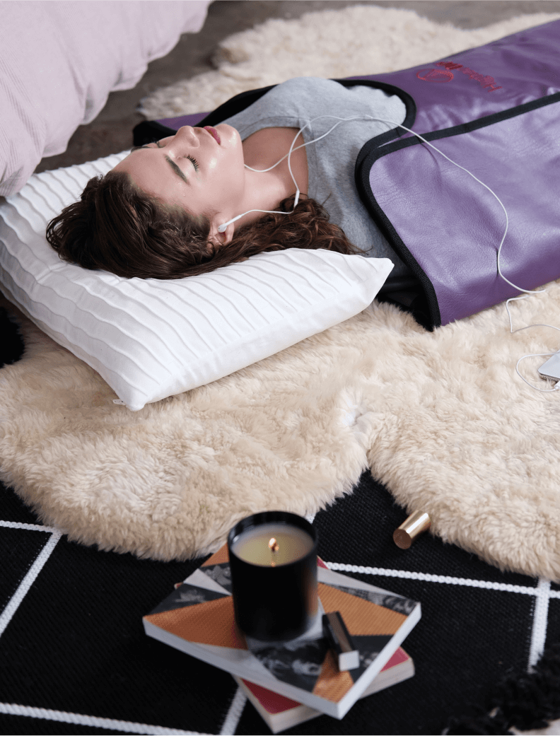 woman using an infrared sauna blanket