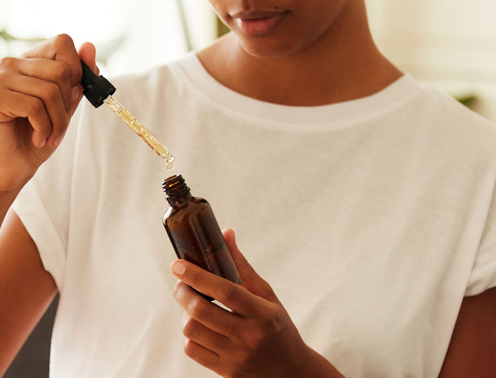 woman with dropper bottle