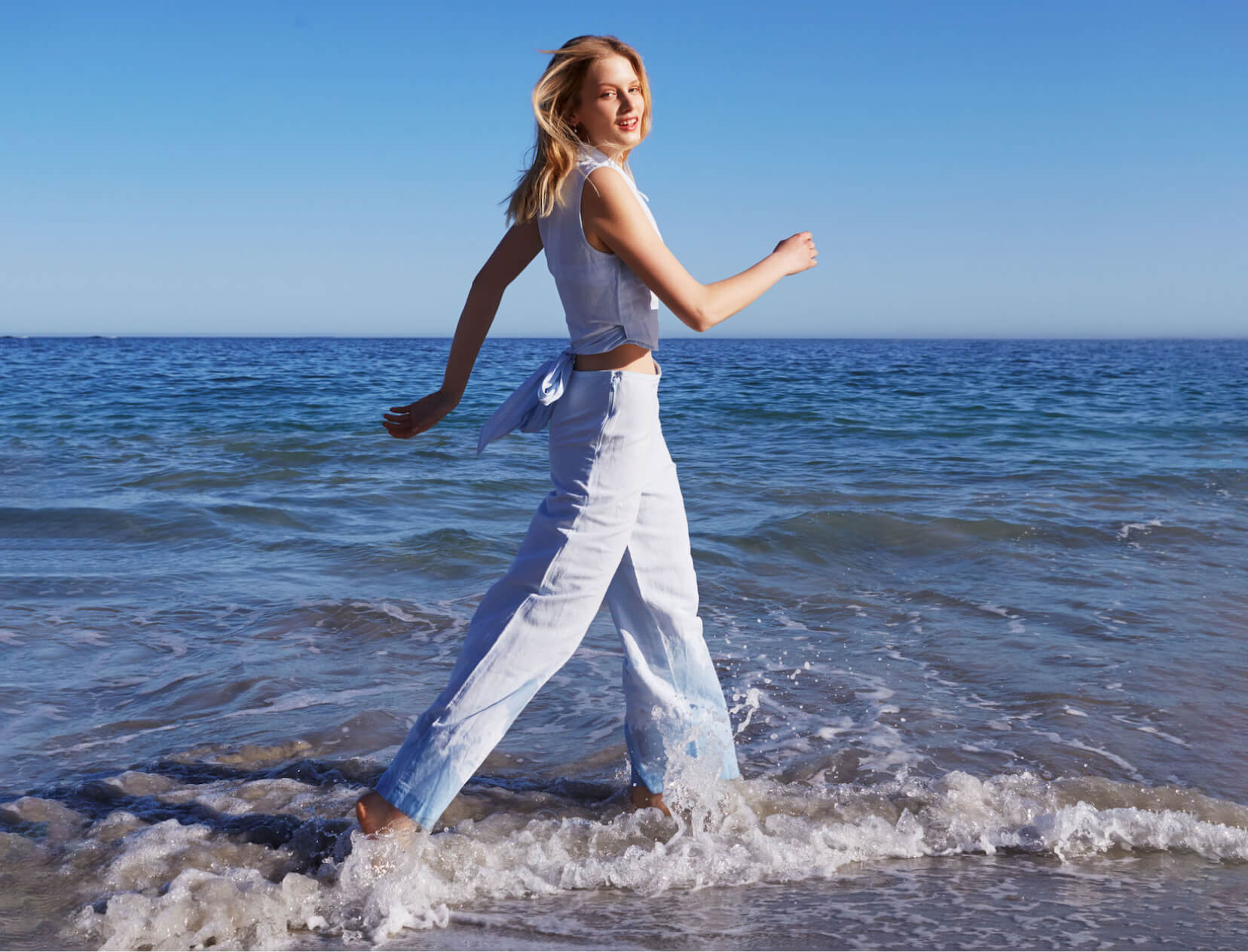 woman walking connected  beach