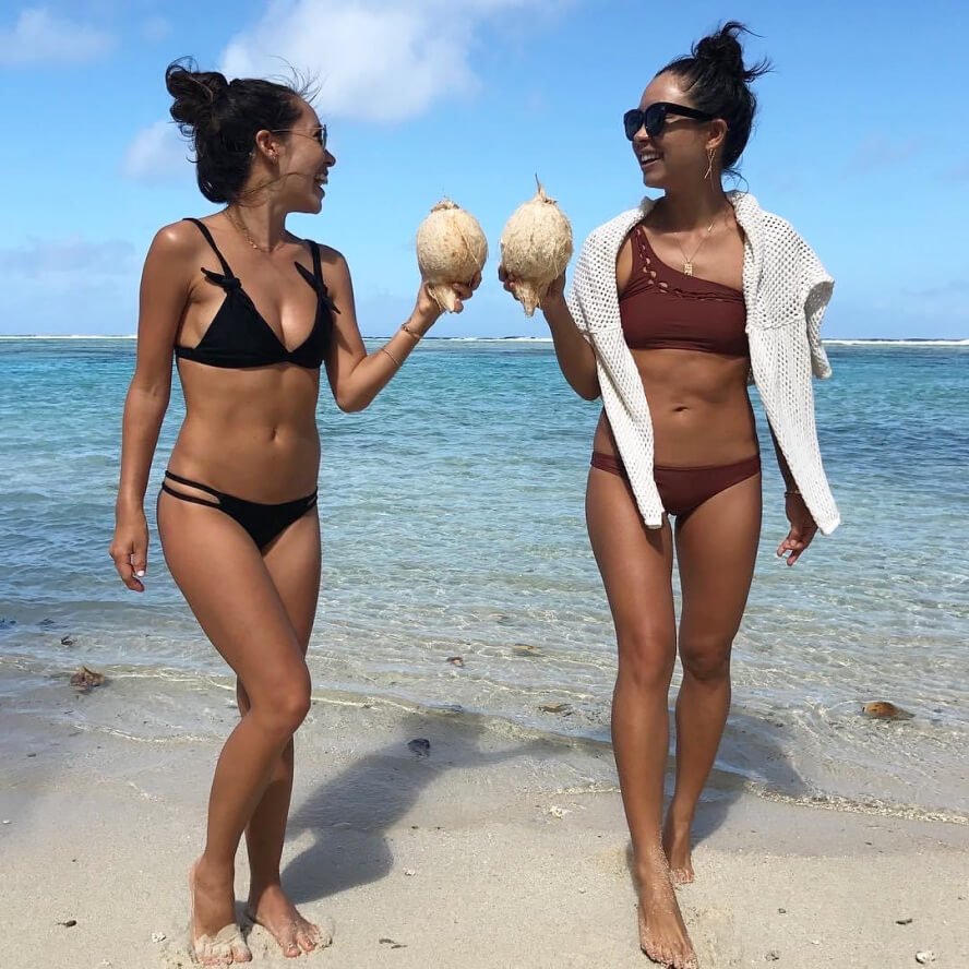 sisters holding coconuts