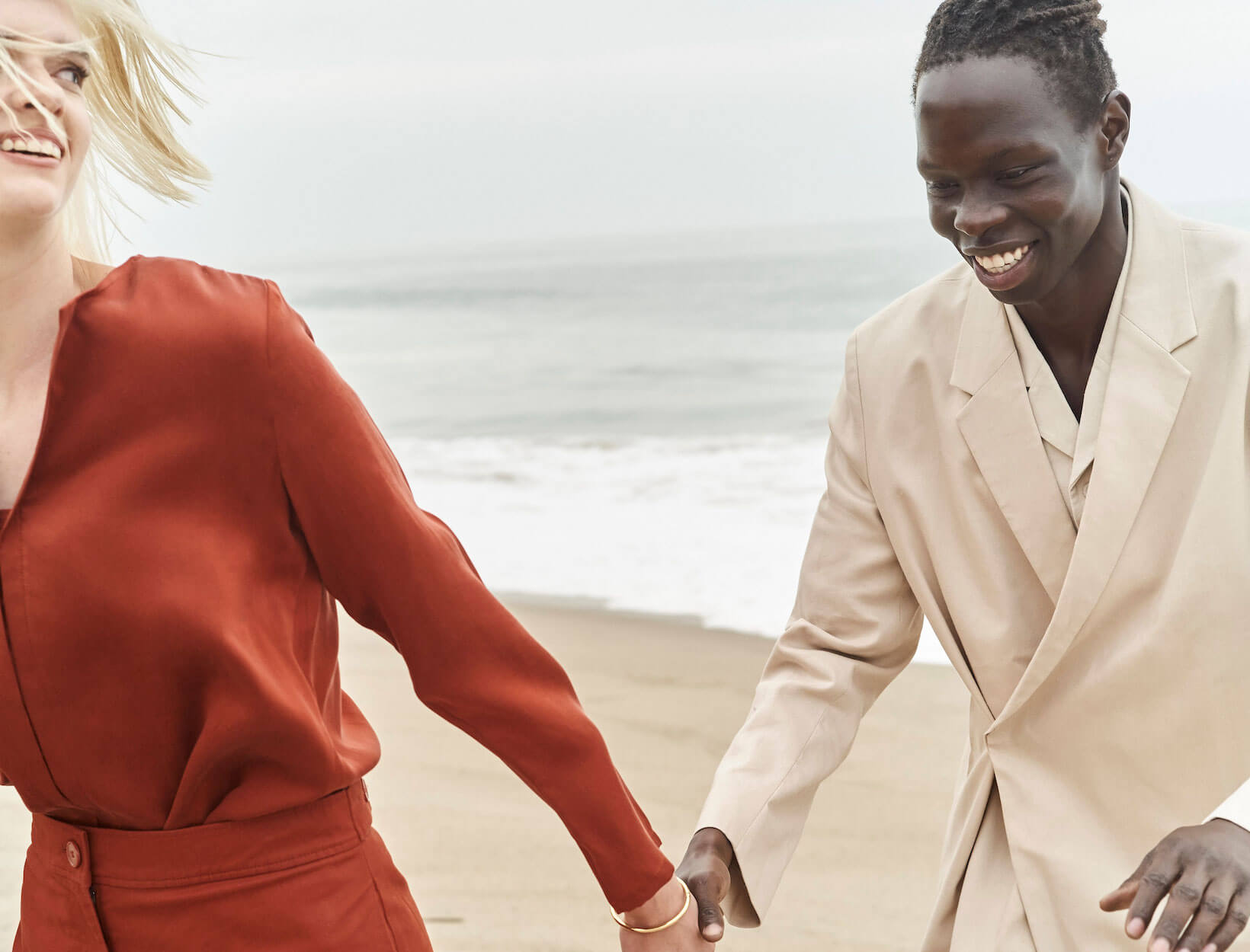 people holding hands on a beach