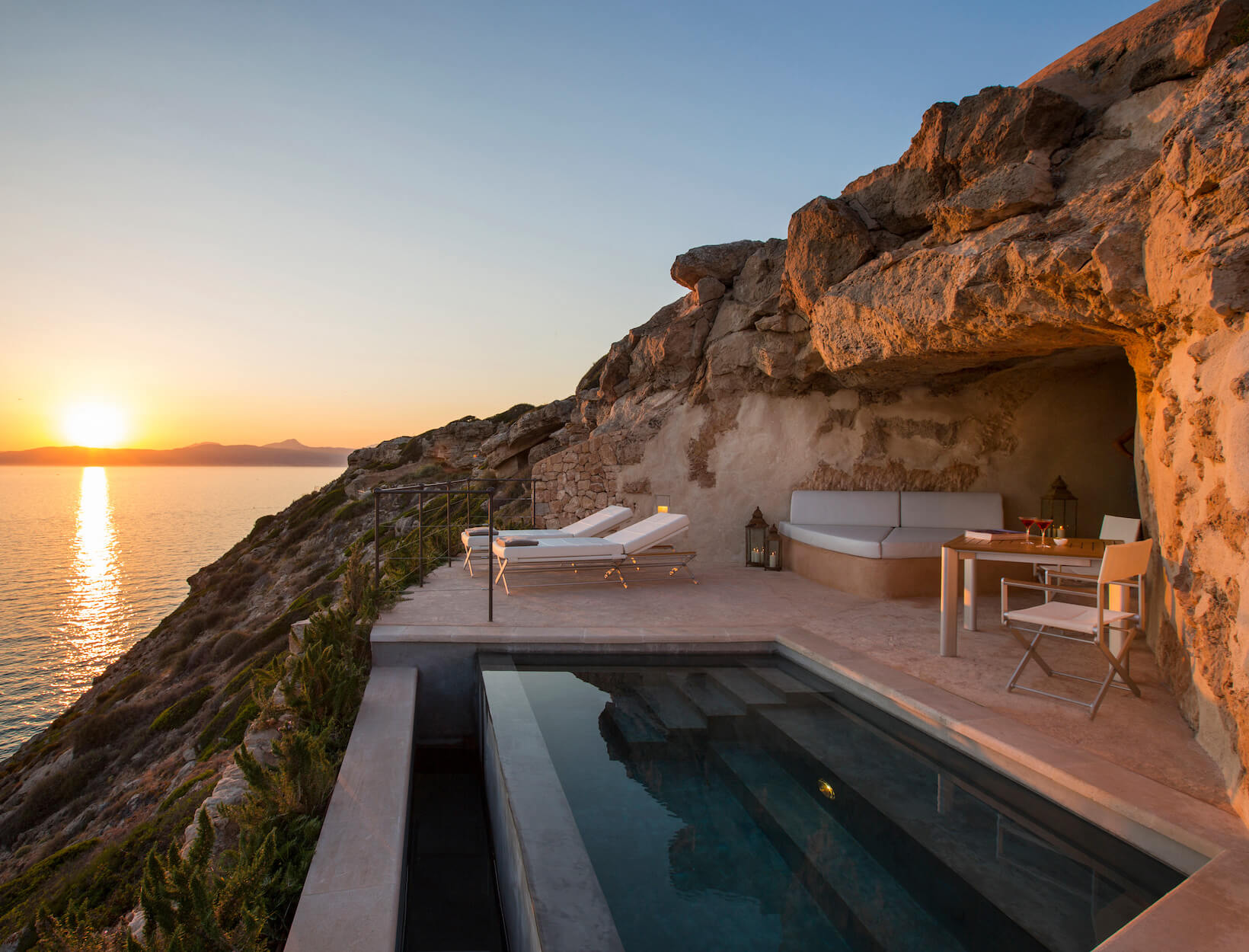 hotel room cut out of rock on the ocean