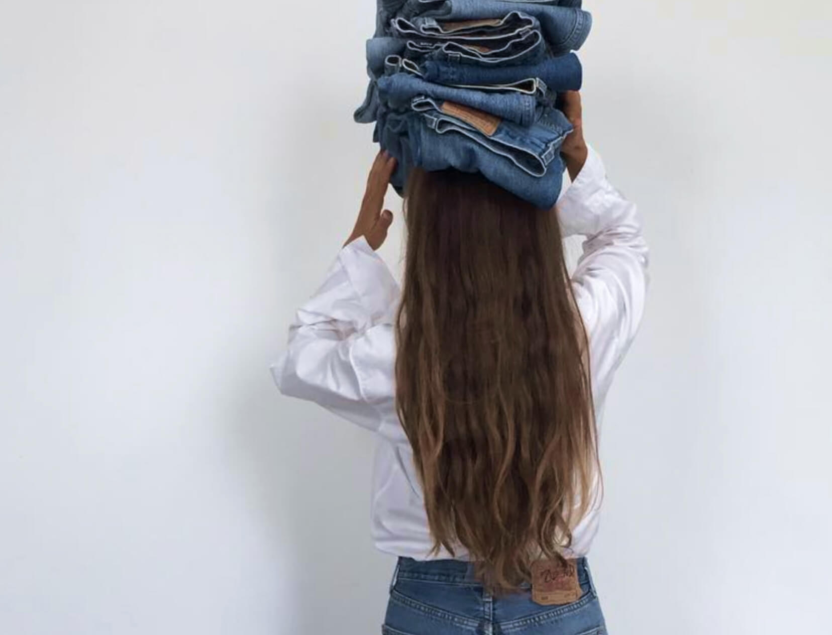 woman holding jeans