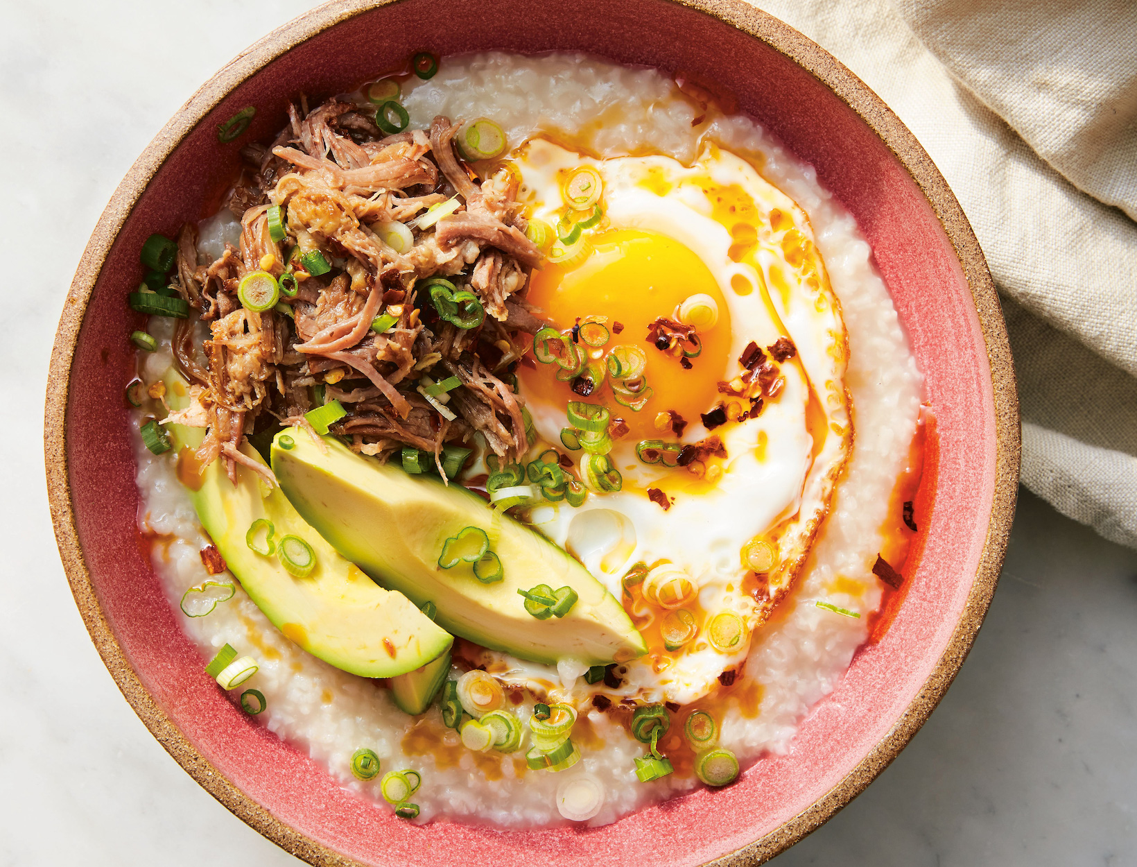 Breakfast Congee with eggs, avocado and scallions