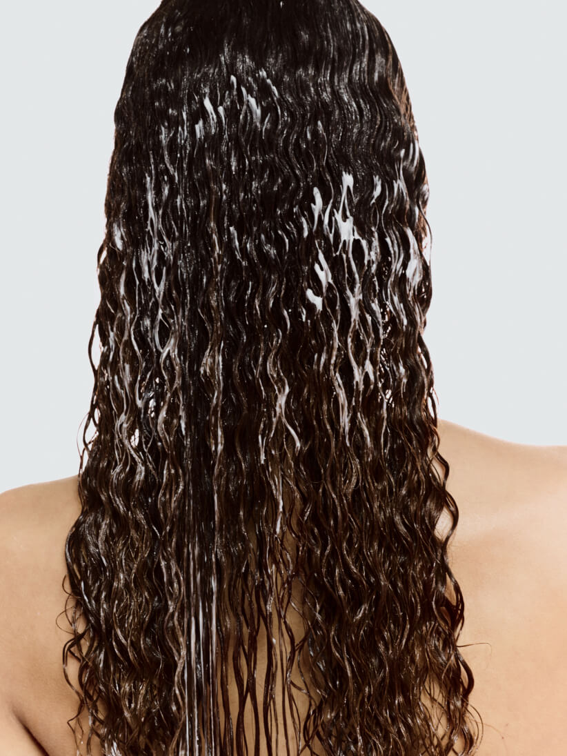 woman utilizing shampoo